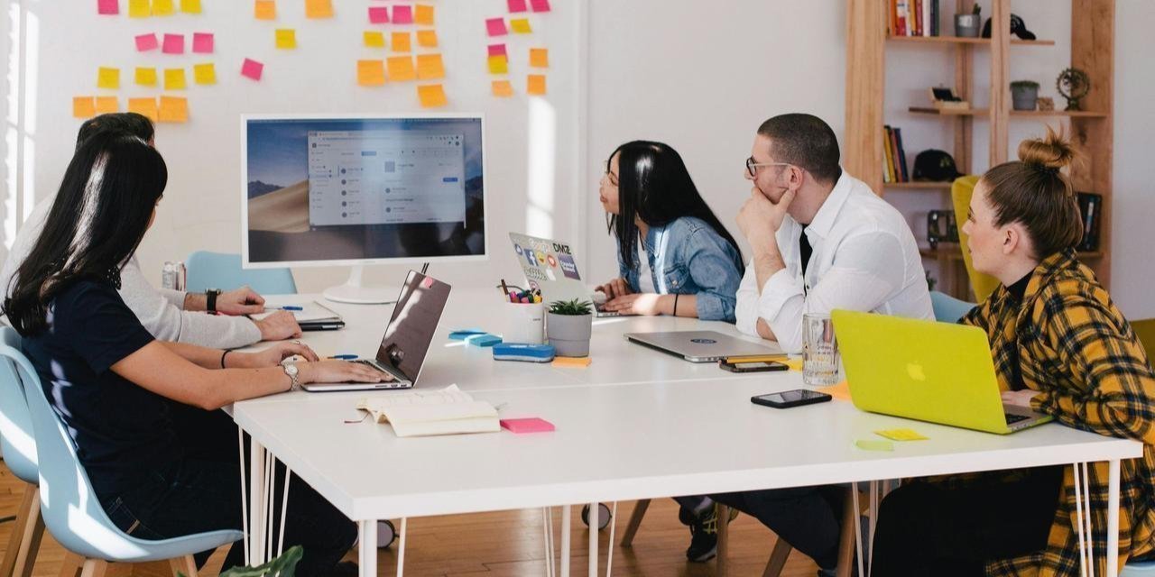 A group of people planning around a whiteboard