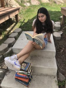 picture of elnaz reading outside