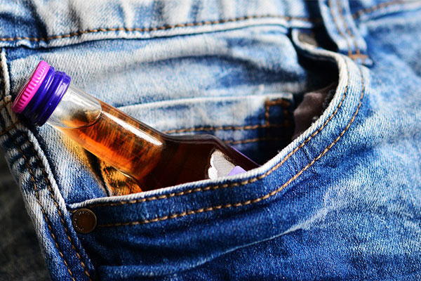 mini bottle of alcohol tucked in jeans pocket. congerdesign, pixabay