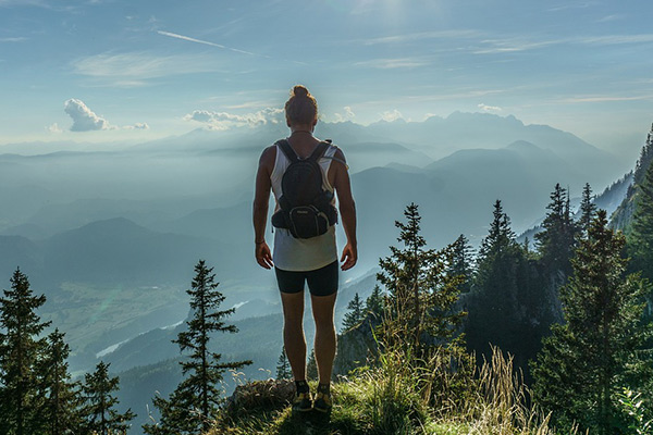 hiker standing overlooking the mountain scenery