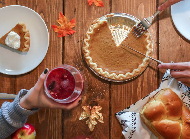 two individuals eating pie