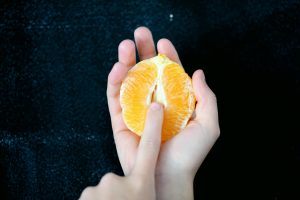 half orange in palm of hand