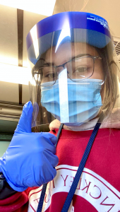 testing volunteer giving a thumbs up while wearing protective face mask