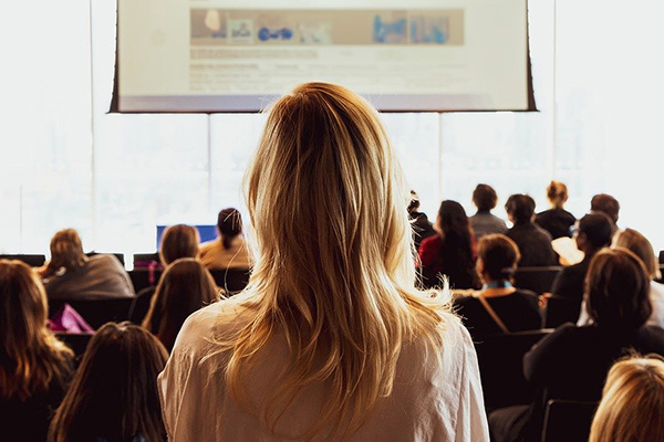 back of individual's head facing a presentation