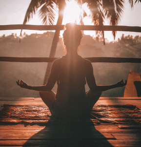 silhouette of woman meditating