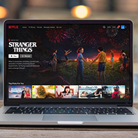 laptop with netflix display of stranger things